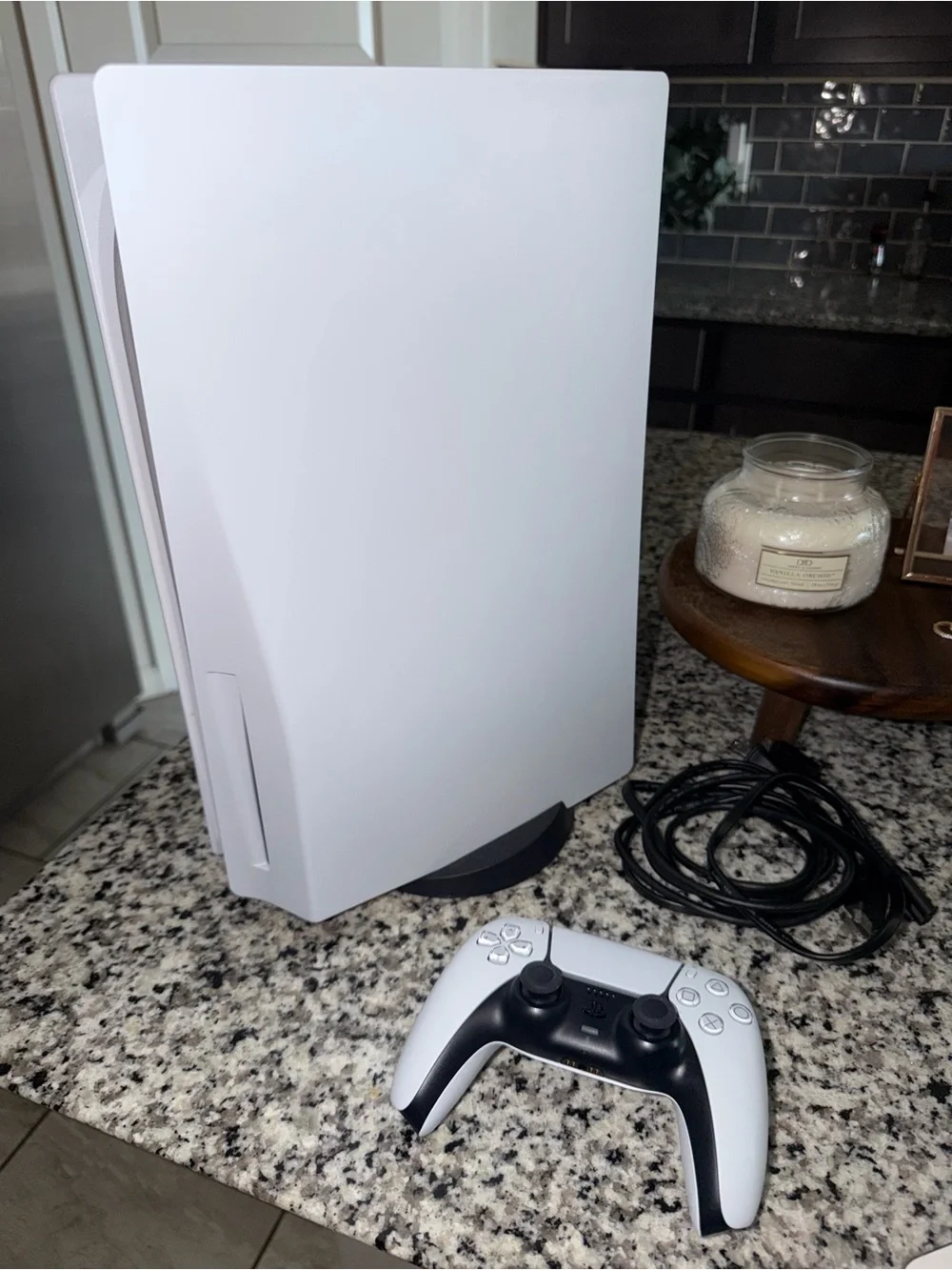 PS5 with HDMI/ power cords, controller, and stand.